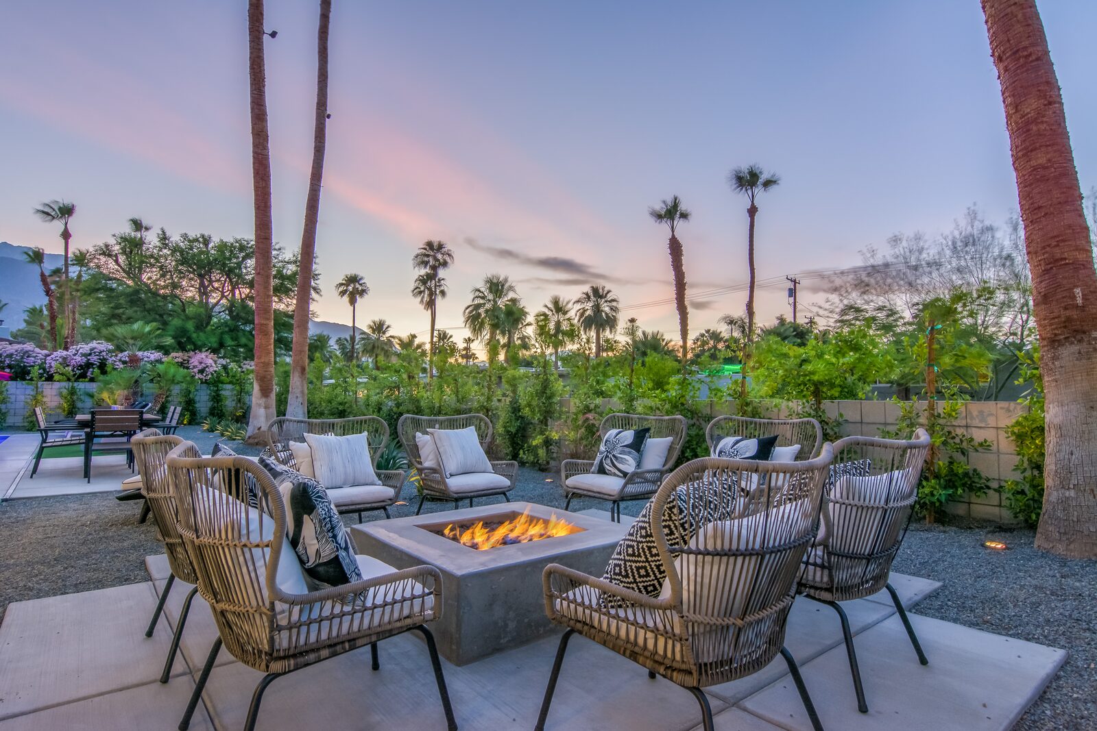 5 Palms Estate outdoor fire pit and lounge at sunset with palms