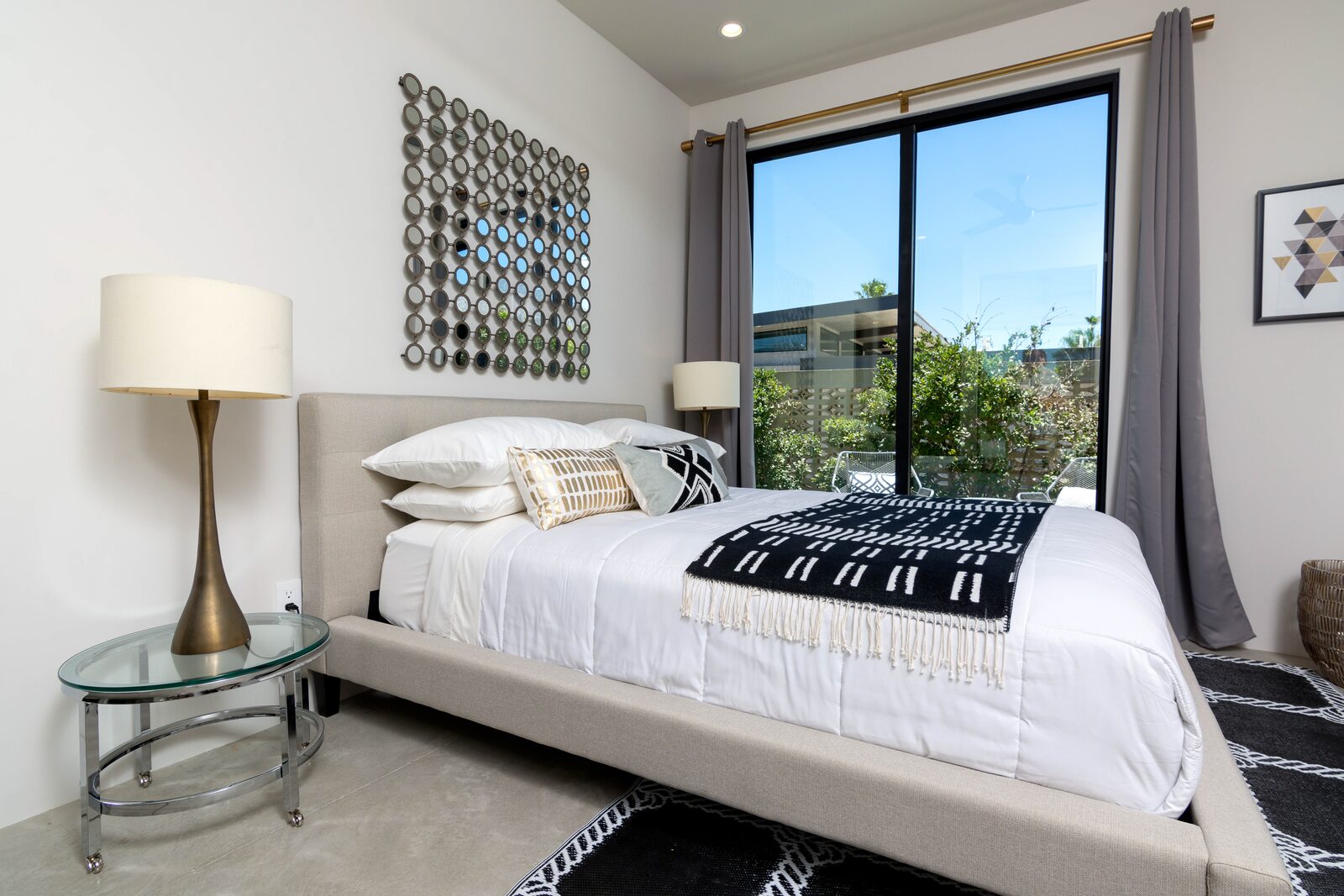 5 Palms Estate guest bedroom with modern nightstand and pool view