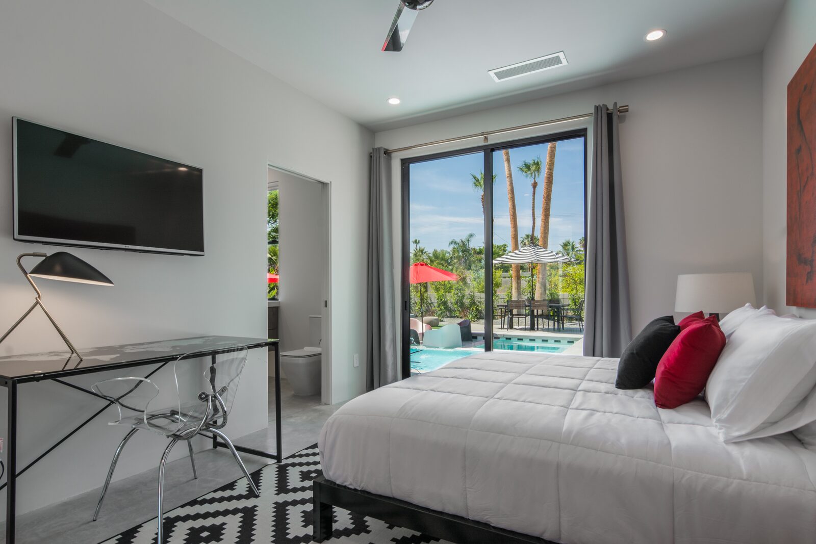 5 Palms Estate bedroom with wall-mounted television and pool view