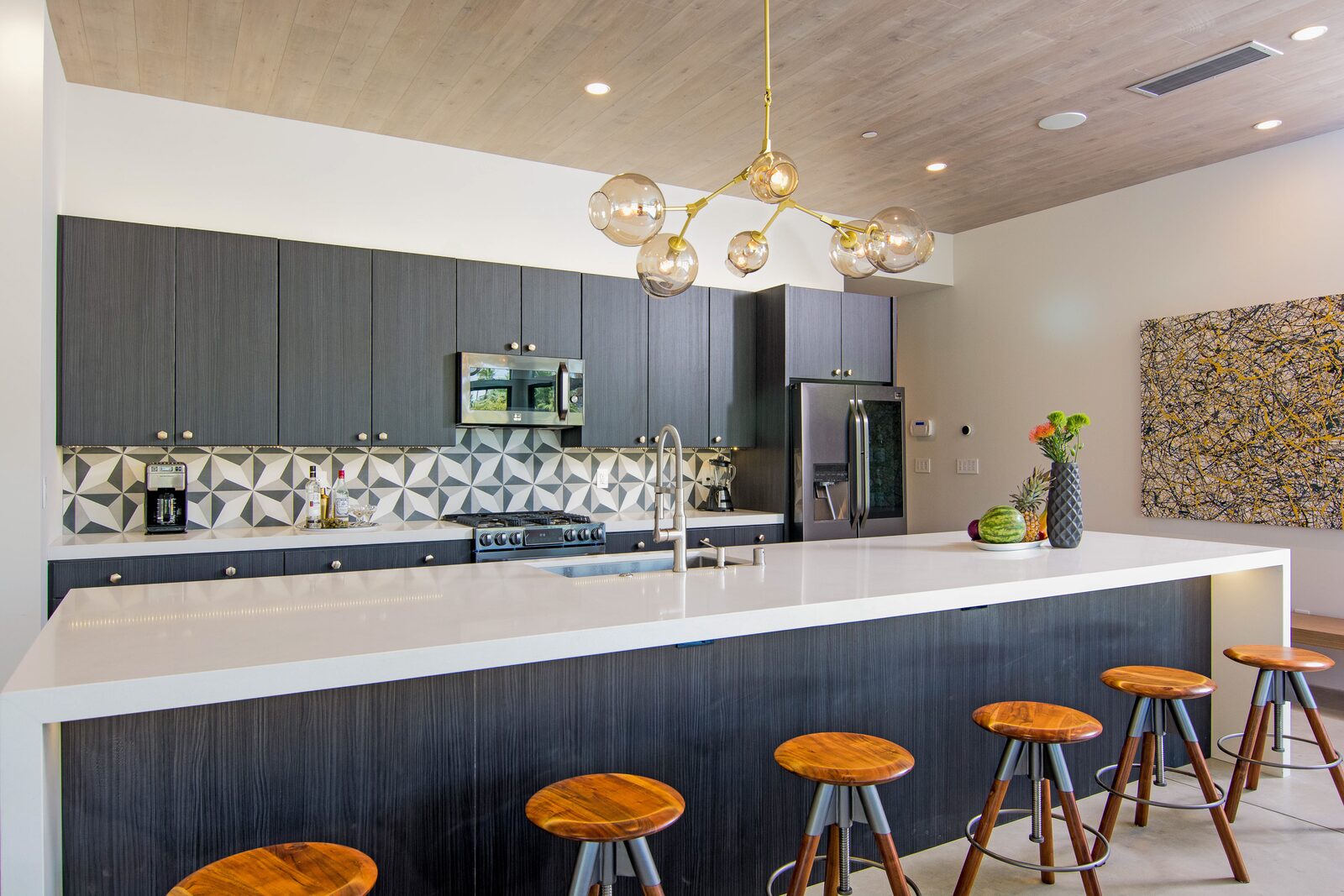 5 Palms Estate kitchen with geometric tile and counter stools