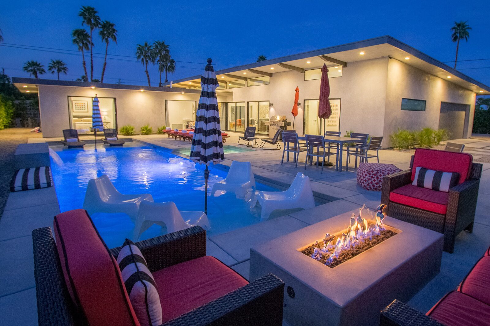 Palms at Park Villa 42-foot pool at twilight with fire pit