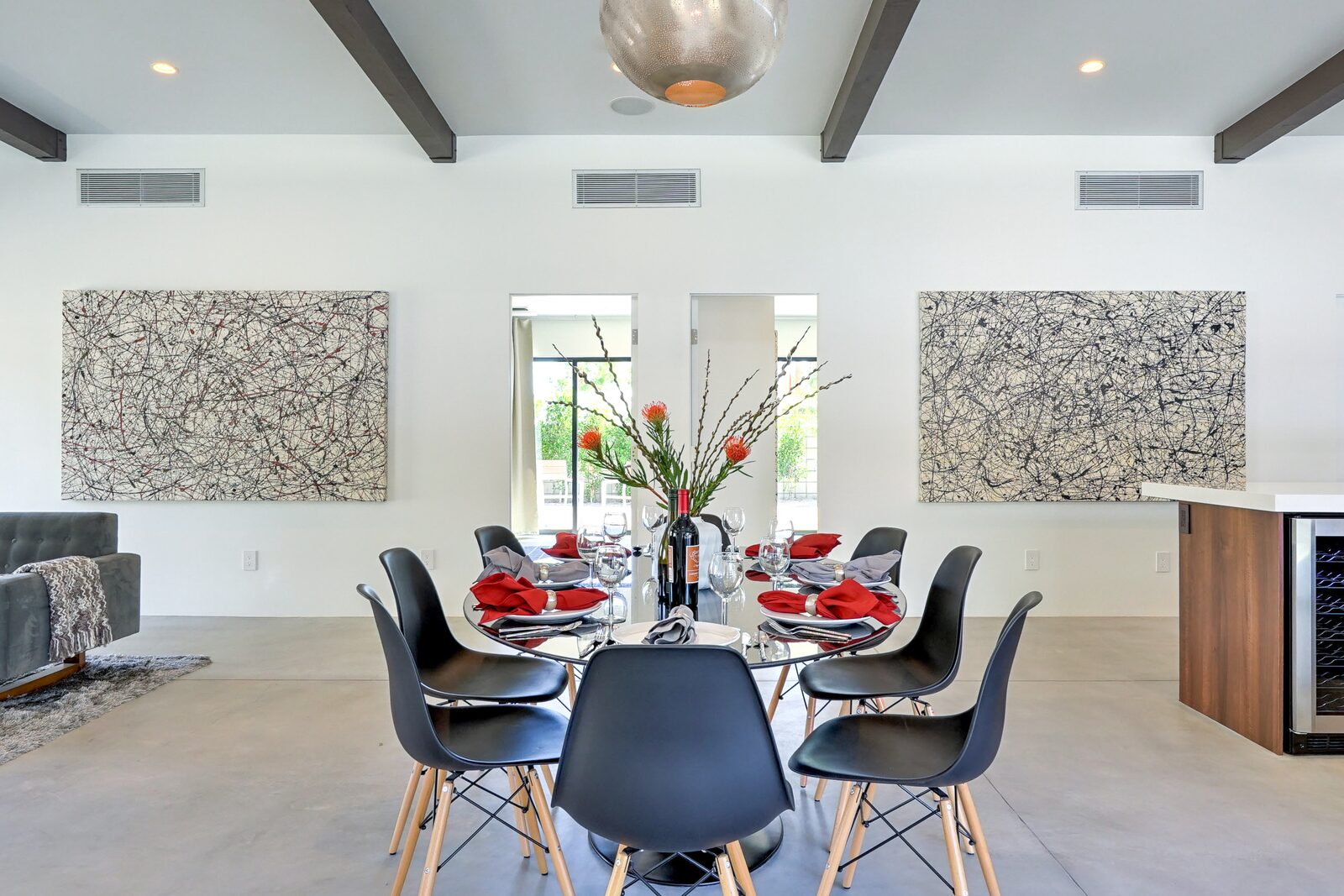 Palms at Park Villa dining room with modern chairs and design-forward art