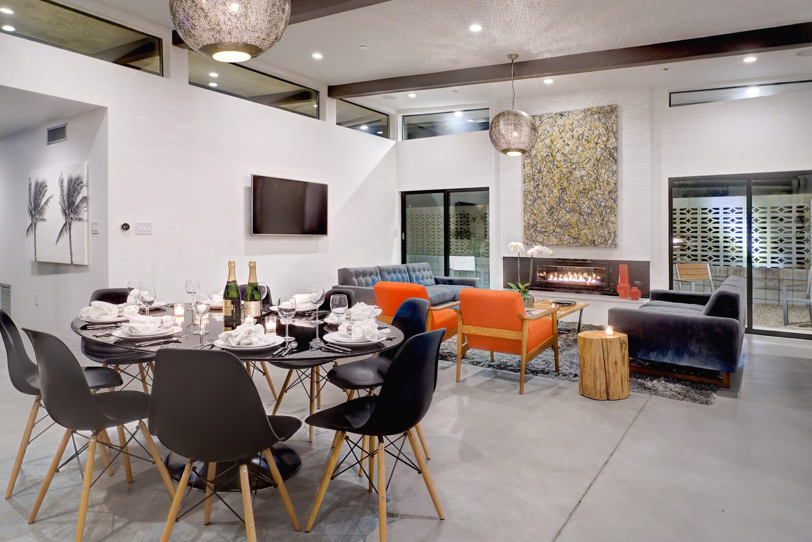 Palms at Park Villa open dining and living area with orange accent chairs