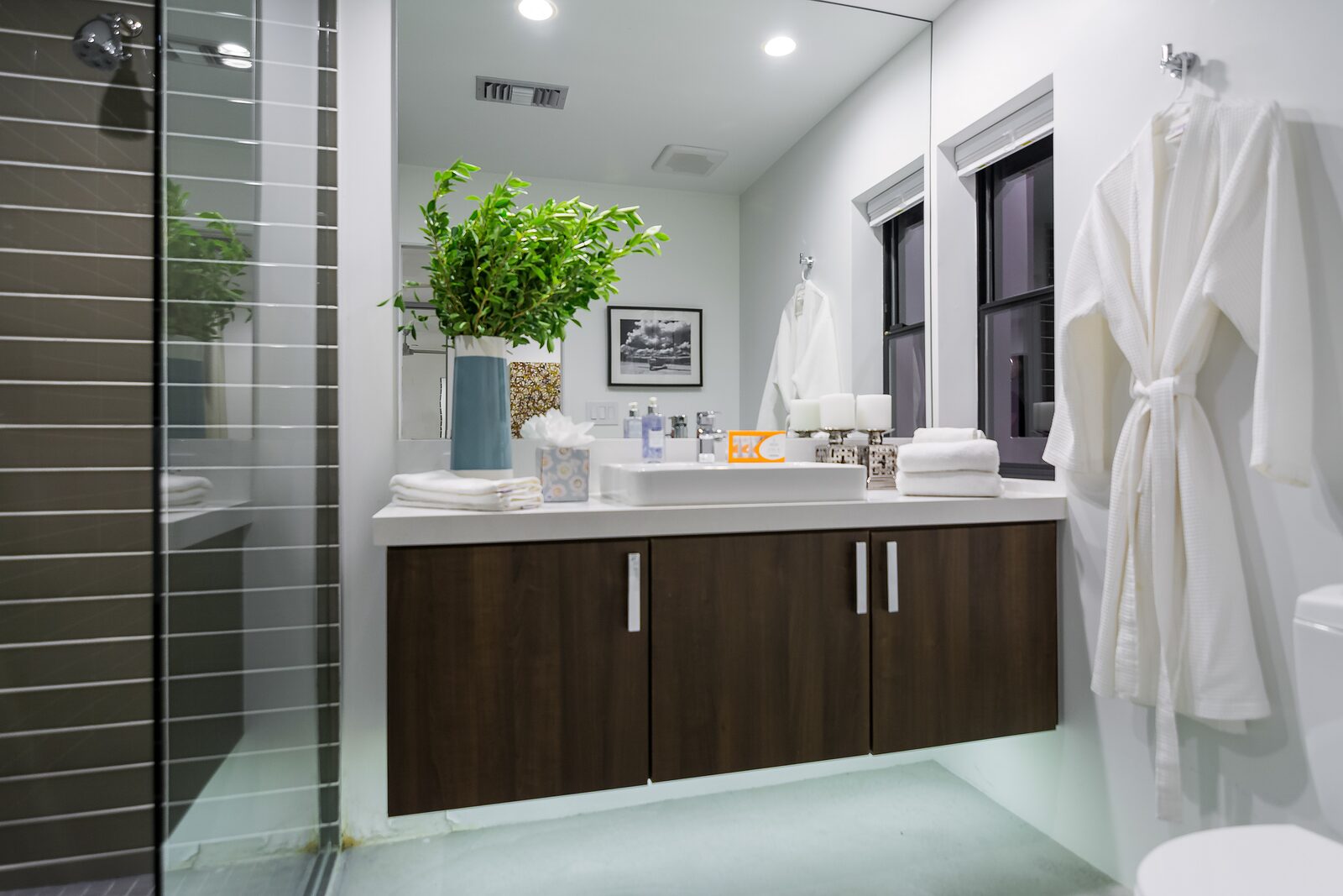 Palms at Park Villa en-suite bathroom with dark cabinetry and plush robes