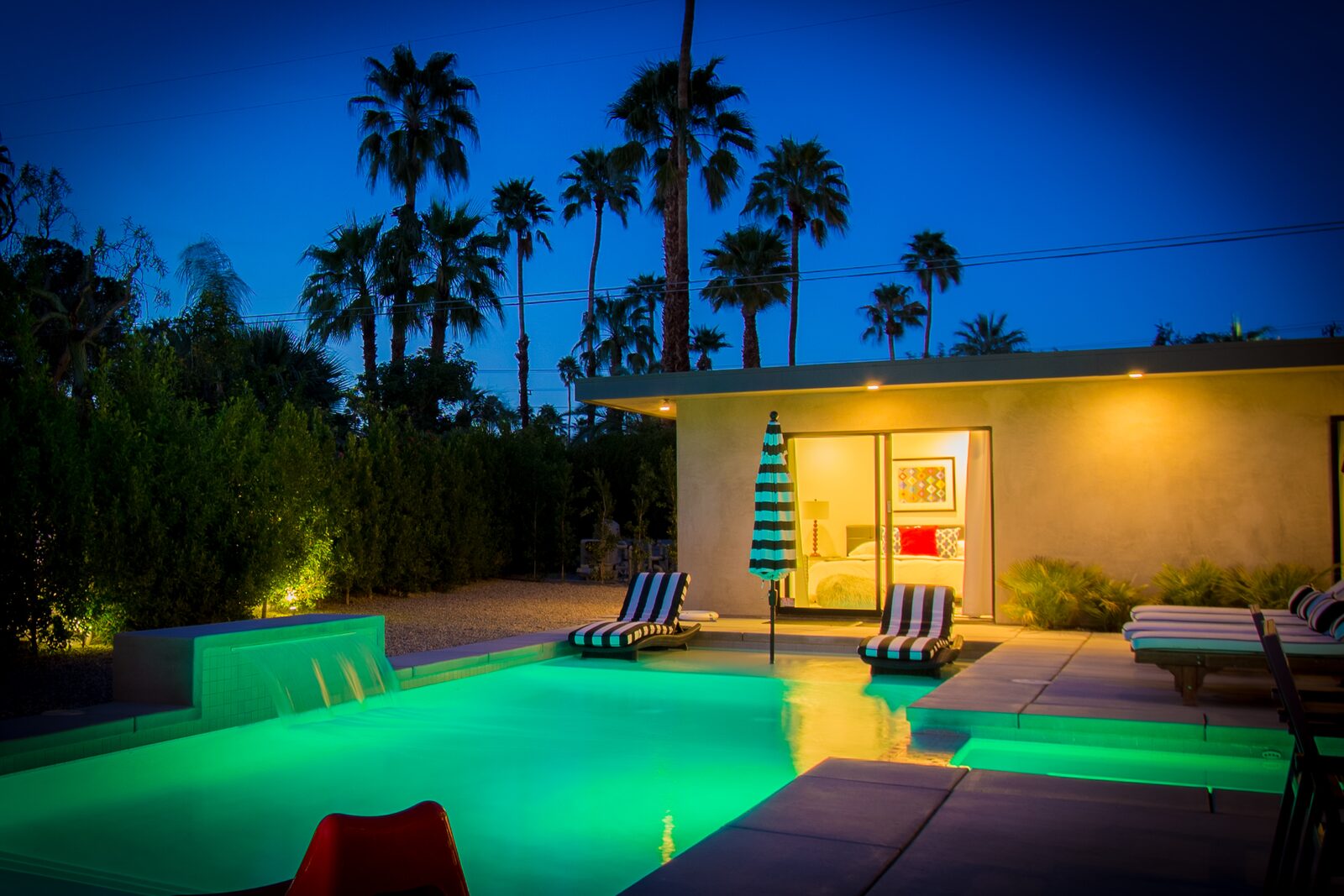 Palms at Park Villa pool illuminated at night with palms