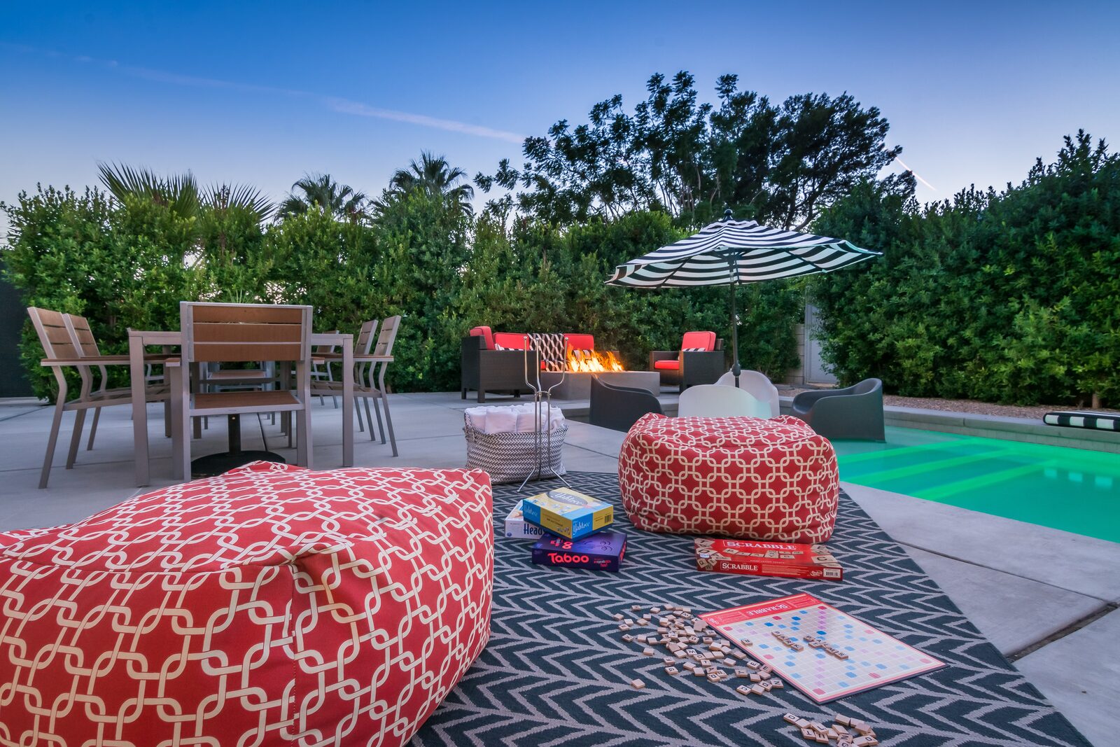 Palms at Park Villa outdoor lounge with striped umbrella and pool